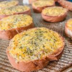 close up picture of cheesy garlic bread after being broiled