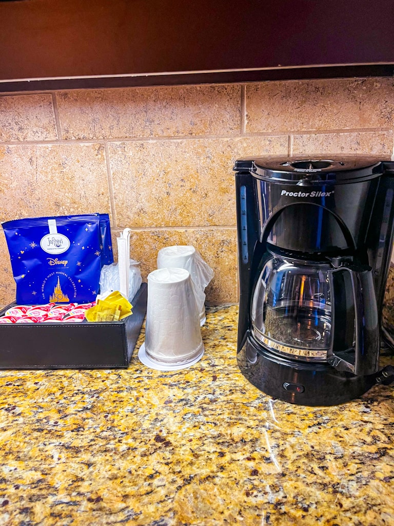 coffee maker with cofee, creamer and paper coffee cups
