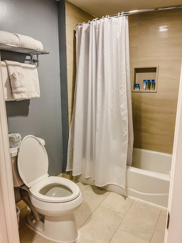 picture of toilet and shower/bath area with folded towels from my disneys beach club room tour