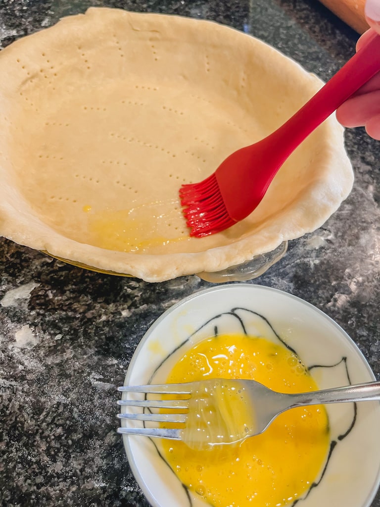 brushing and egg mixture over the unbaked pie dough