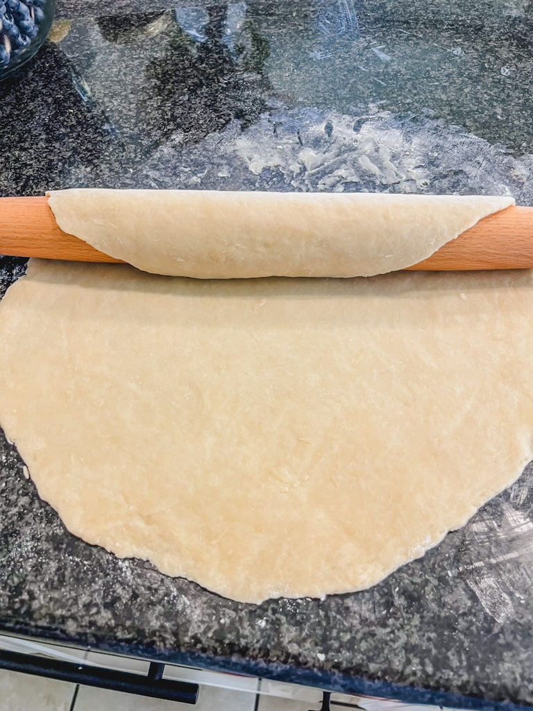 rolled out dough ready to be placed in pie dish
