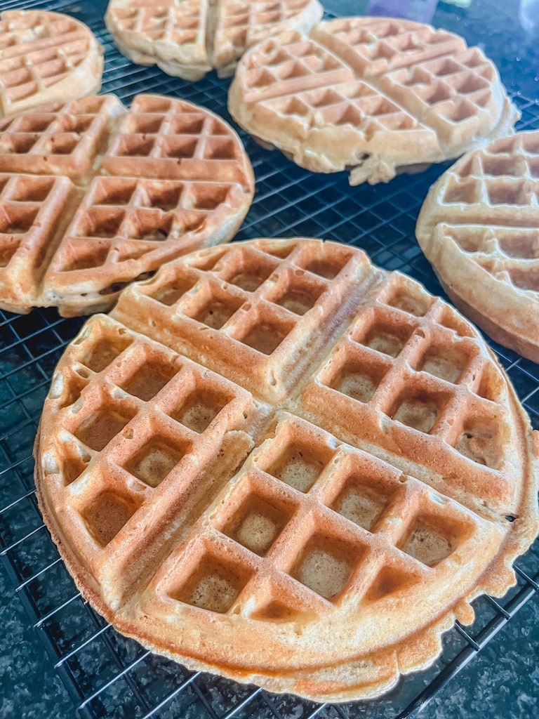 close up of freshly made belgian waffles on cooling rack