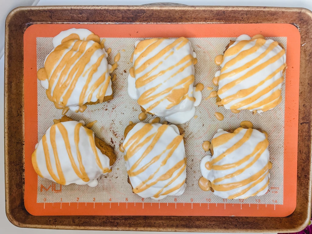 overhead picutre of pumpkin scones on the baking sheet with icing 