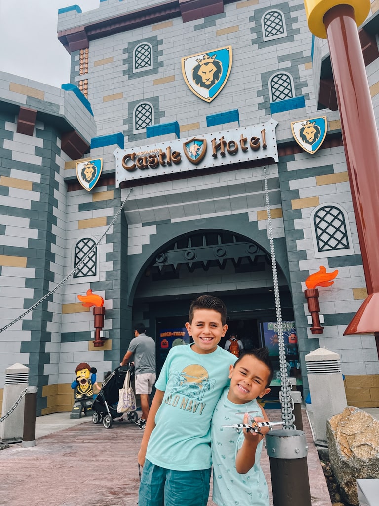 picture of my two sons standing in front of the entrance to the LEGOLAND castle hotel
