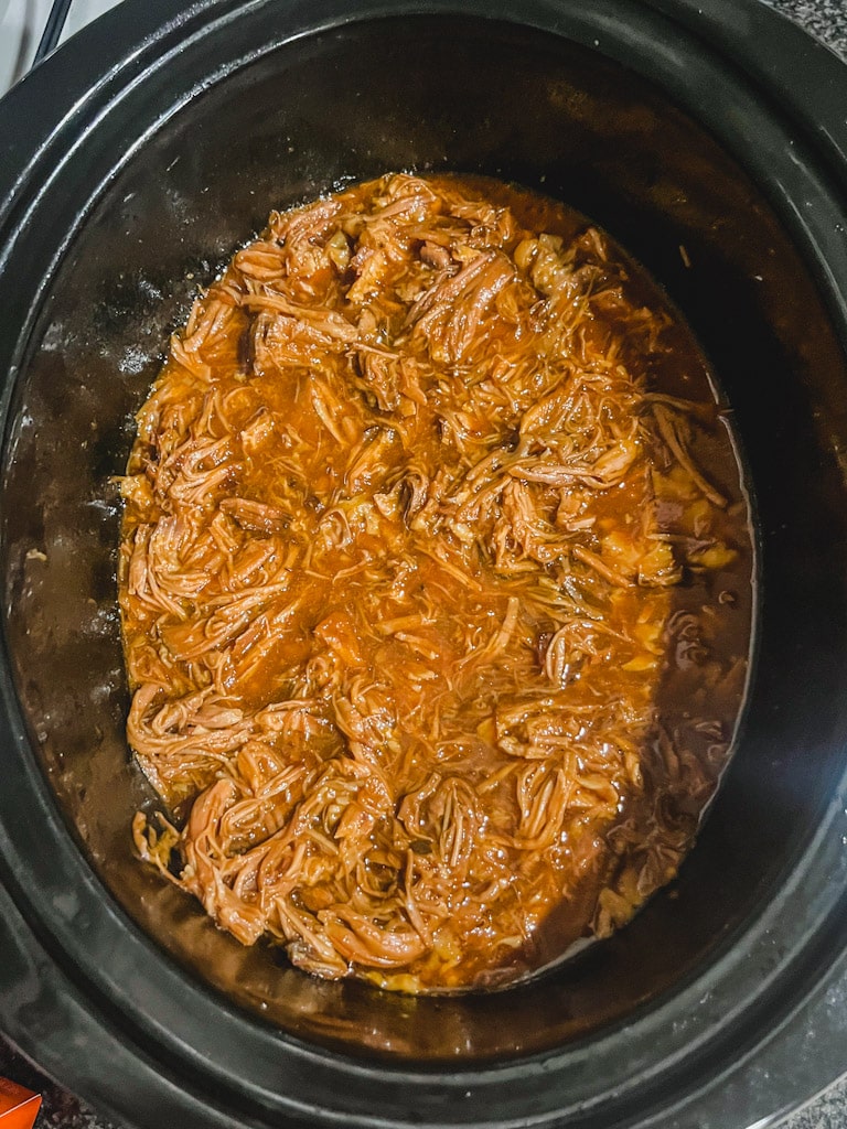 overhead picture of pulled pork that's been shredded once done cooking
