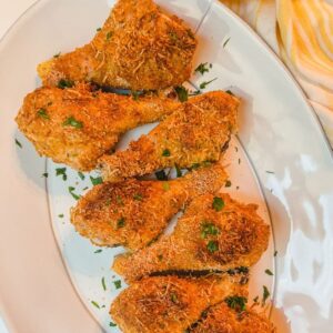 easy oven fried Italian chicken drumsticks close up on white serving platter