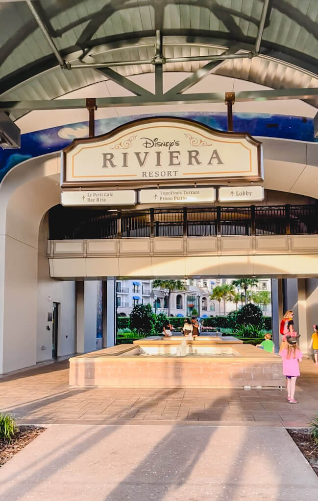 view of Disney's Riviera Resort sign outside of the building showing where to go to the lobby and restaurants.