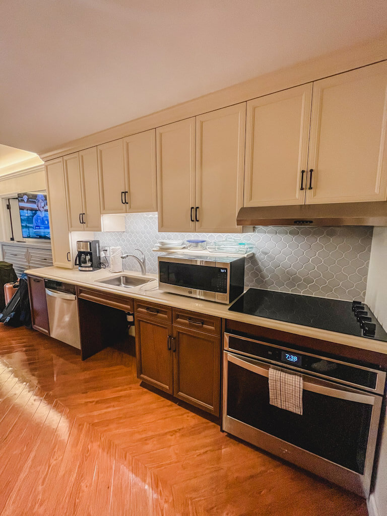 large open kitchen with stove, oven microwave, sink, with big white cabinets at the Riviera resort.