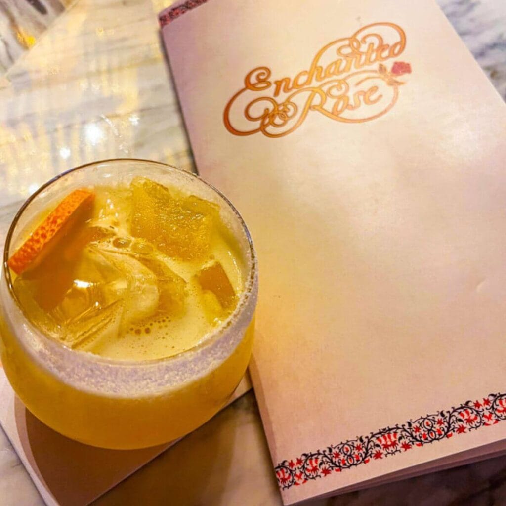 sunny margarita cocktail with menu in backgroud at enchanted rose at disney's grand floridian resort.