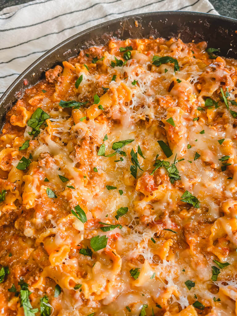 close up view of the lasagna casserole in the blue cast iron skillet.