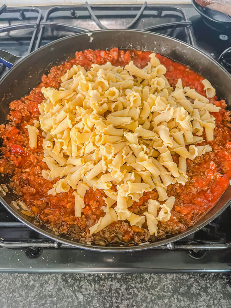 pasta has been added to skillet with marinara sauce and beef mixture in large skillet for recipe for lasagna skillet.