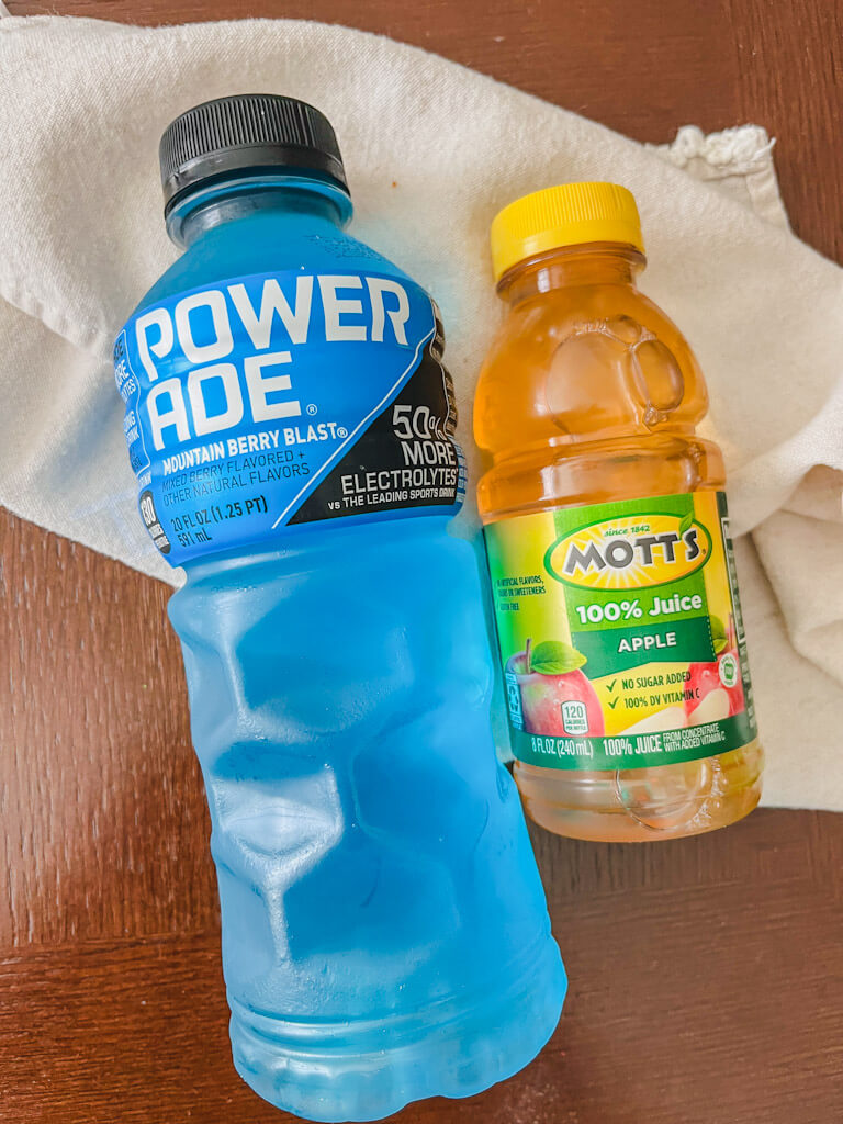blue powerade and apple juice bottles for a drink for a goofy movie dinner night.