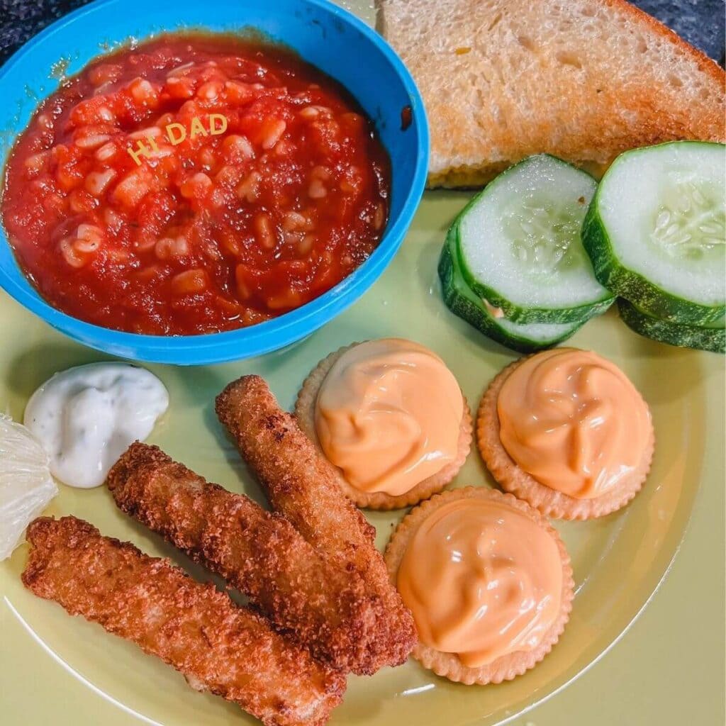 hi dad tomato soup, grilled cheese sandwiches, and cheese crackers on a yellow plate for a goofy movie dinner night.