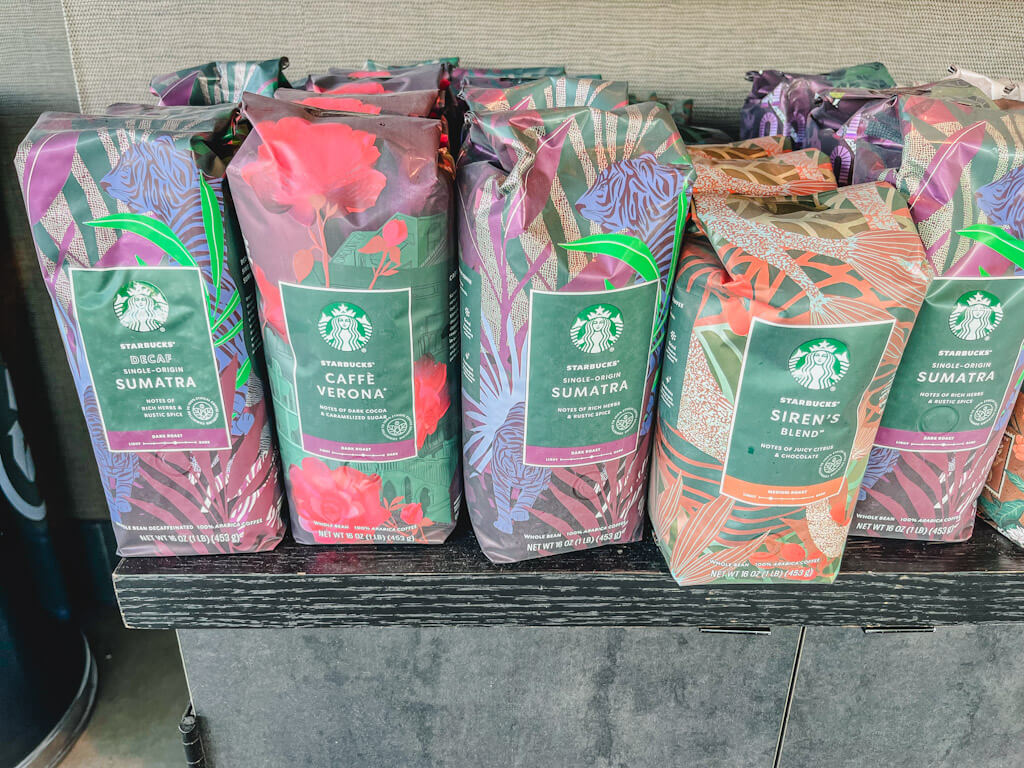 5 different Starbucks coffee whole bean bags on a counter.