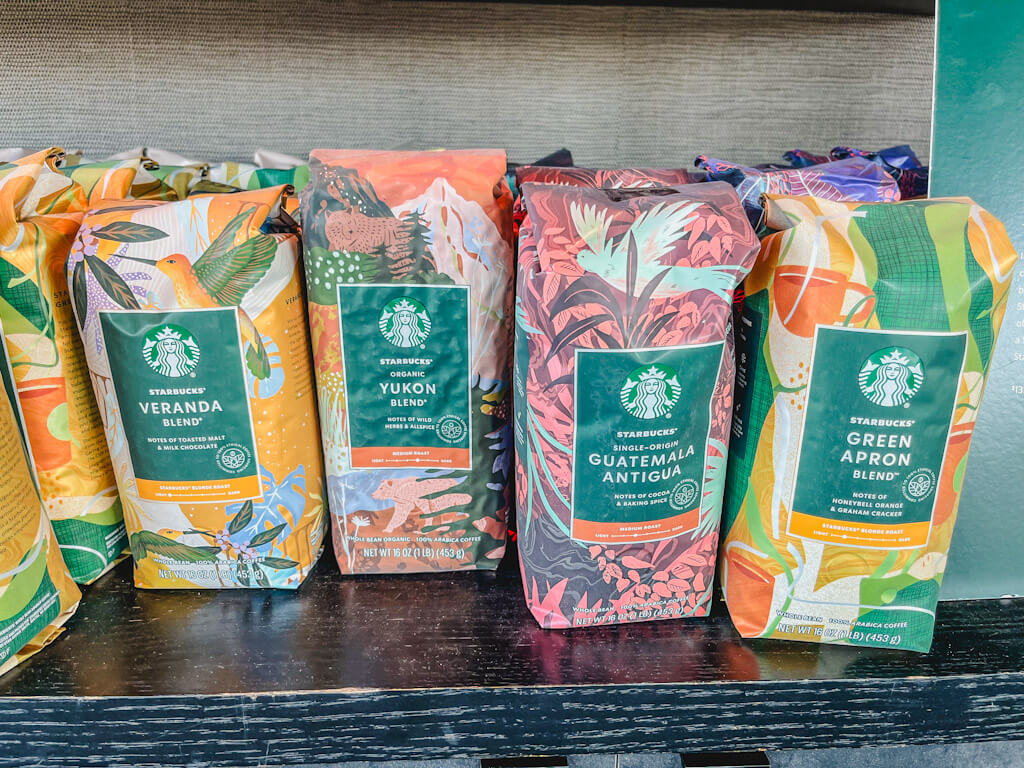 various whole bean Starbucks coffee bags on a counter.