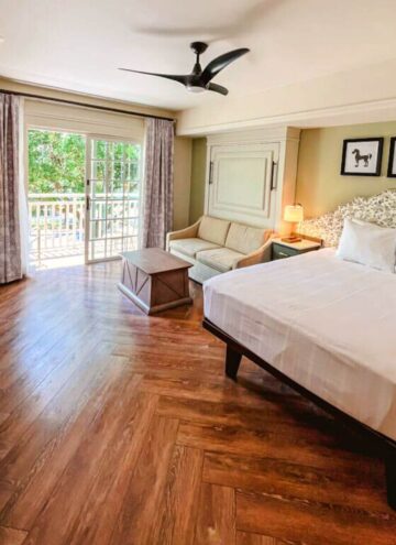 corner view of the bedroom and living space area in a deluxe studio villa in my disney's saratoga springs studio tour.