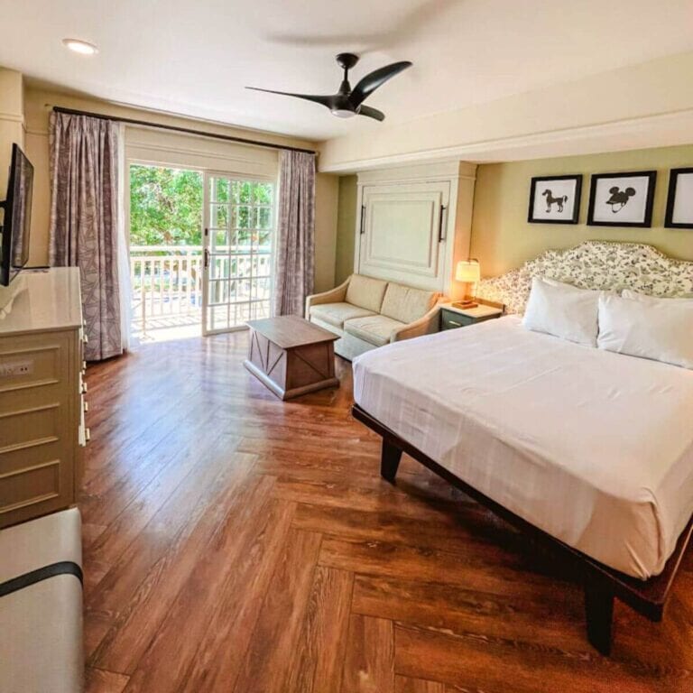 corner view of the bedroom and living space area in a deluxe studio villa in my disney's saratoga springs studio tour.