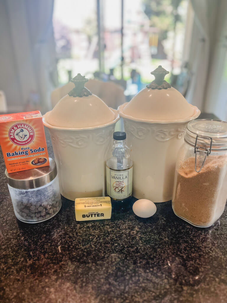 ingredients laid out on a black countertop to make mini chocolate cookies.