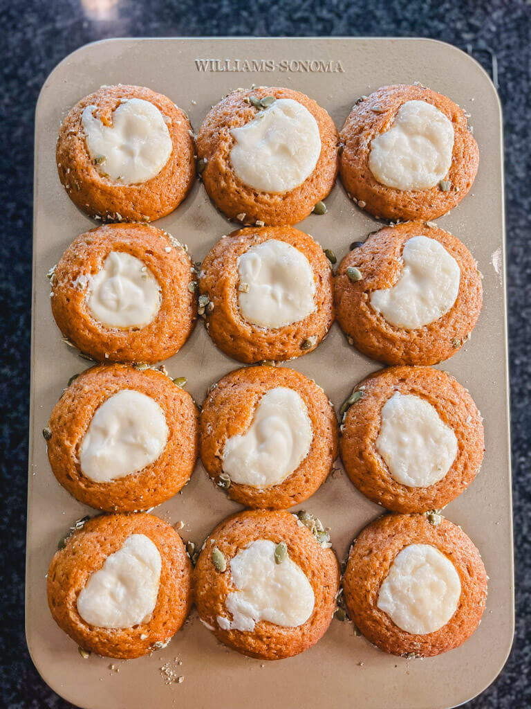starbucks copycat pumpkin cream cheese muffins cooling in the baking pan after being baked.