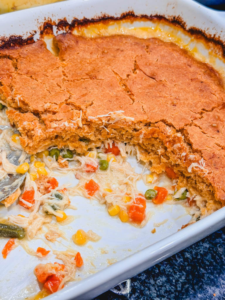 close up of chicken casserole with servings taken out of the dish. 
