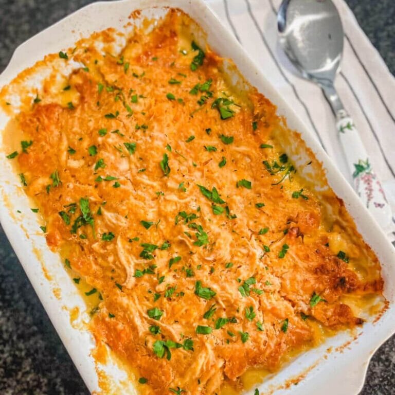 overhead image of red lobster chicken cobbler recipe in a white casserole dish.