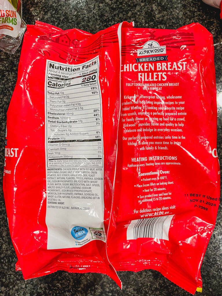 a red bag of aldi chicken showing the ingredients and how to cook on the backside of the bag.