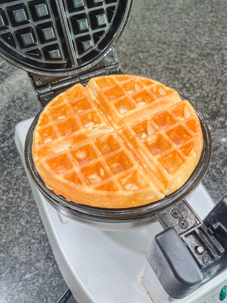 a delicious golden brown waffle after baking in the waffle iron.