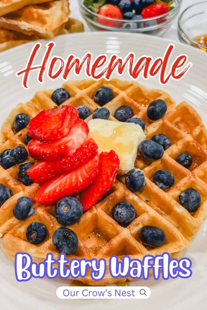 a closeup image of a waffle with berries and a pat of butter with the text, "Homemade Buttery Waffles" written over the image for Pinterest.