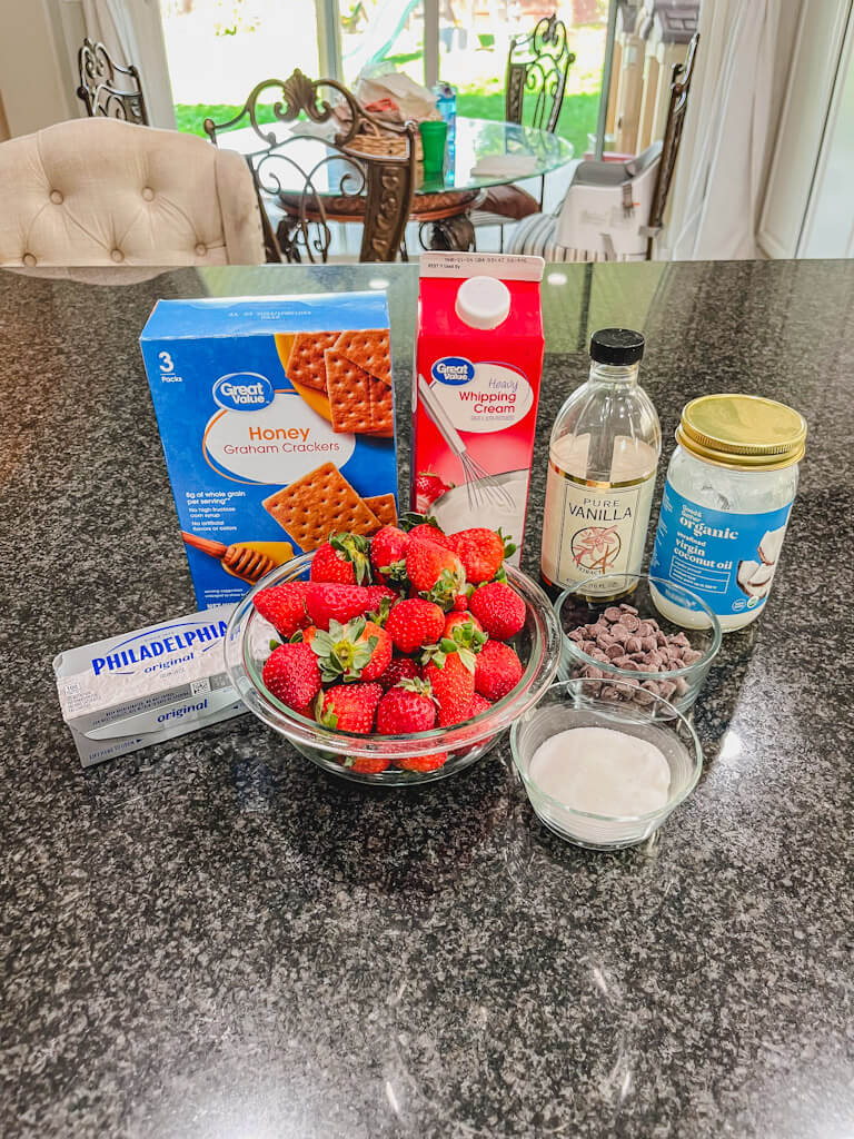 ingredients for deviled strawberries tiktok recipe laid out on a black counter top.