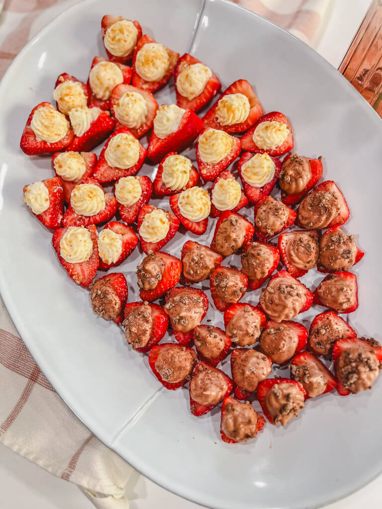 chocolate cheesecake strawberries and plain cheesecake strawberries on a white serving dish.