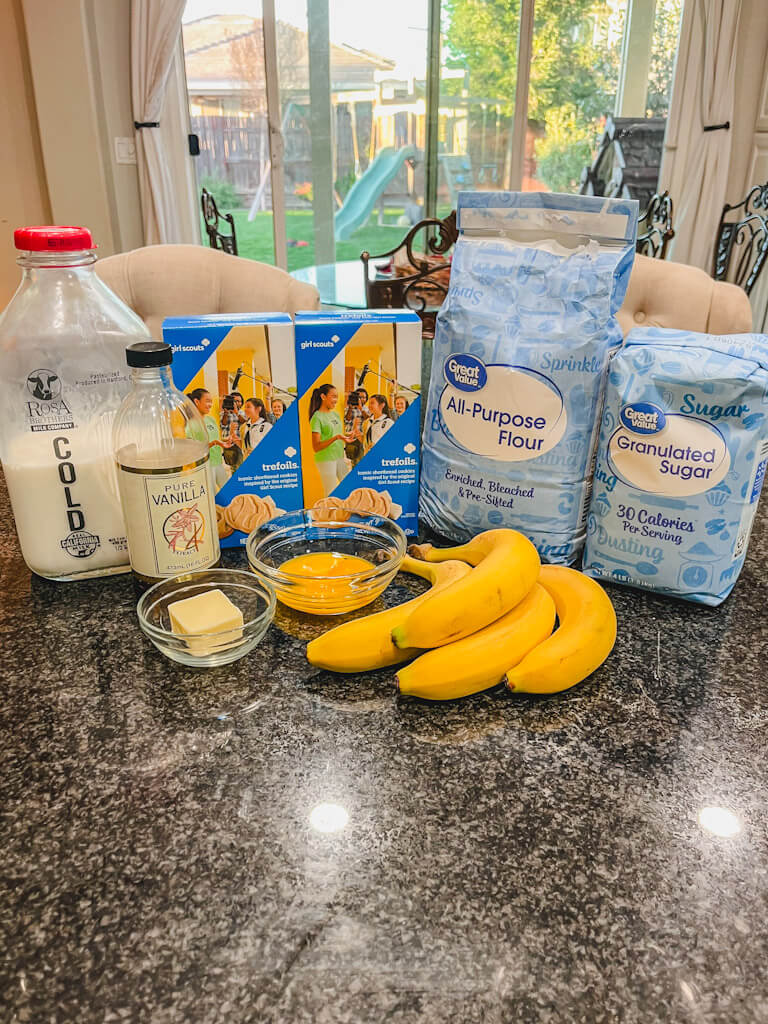 ingredients for trefoils banana pudding laid out on a black counter.