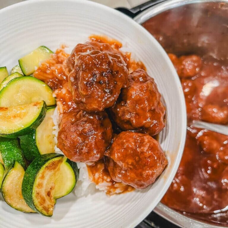 instant pot sweet and sour meatballs served over white rice in a white bowl.