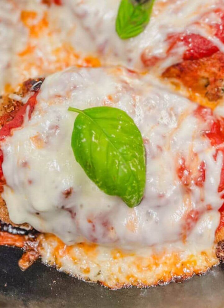 close up of one pan chicken parmesan in a cast iron skillet.