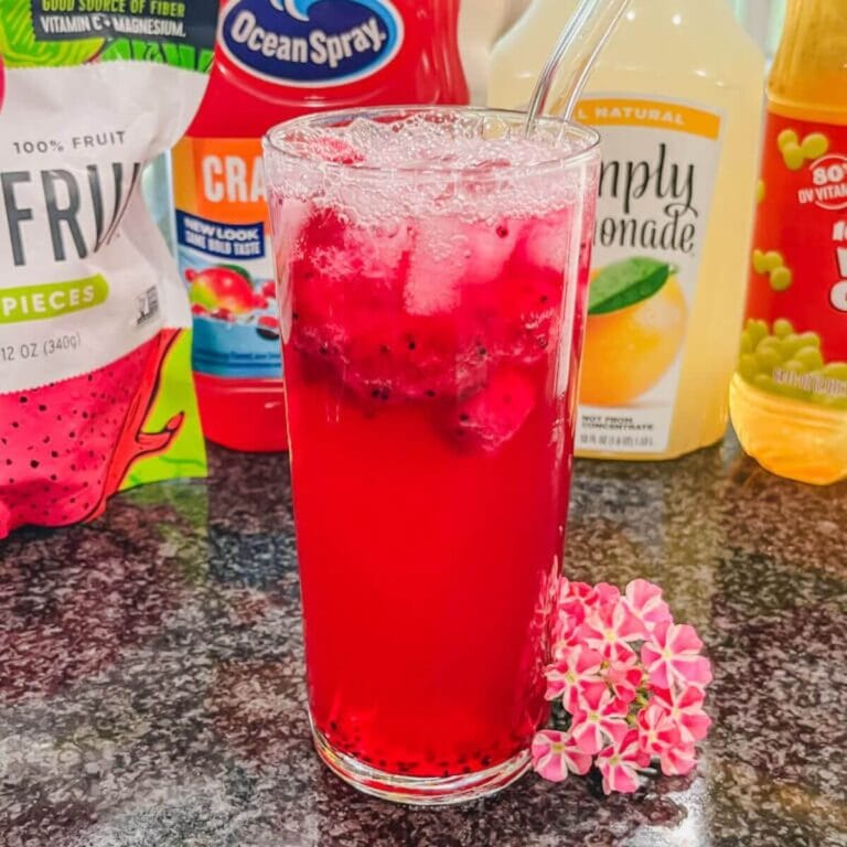 mango dragonfruit starbucks refresher in a glass in front of the ingredients.