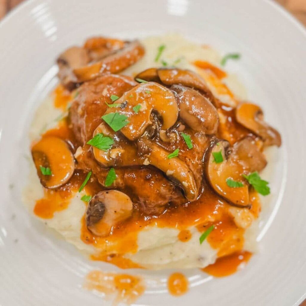 instant pot salisbury steak with mushroom gravy on a white dinner plate.