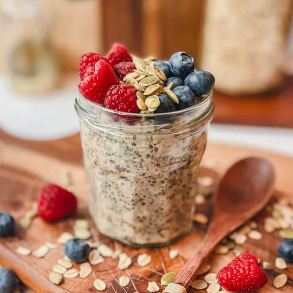 overnight oats in a small jelly jar on a cutting board.