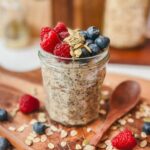 overnight oats in a small jelly jar on a cutting board.