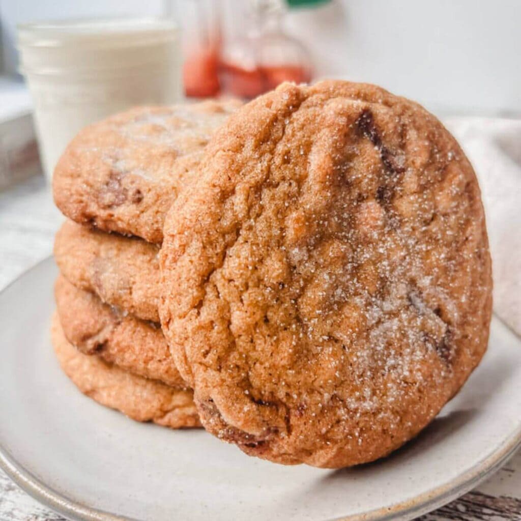 a stack of reese's peanut butter cookies on a white plate.
