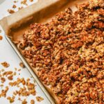 overhead view of healthy homemade granola on a sheet pan.