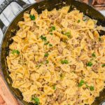 overhead view of creamy beef and bowtie pasta in a skillet.