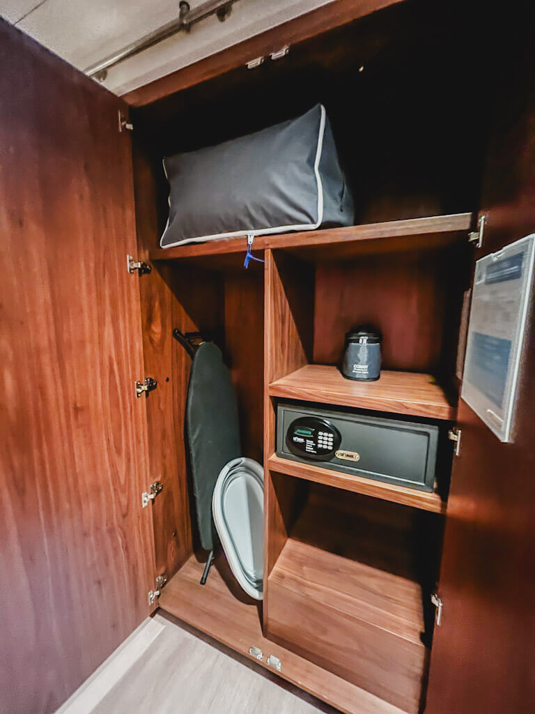 a closet with extra bedding, iron board, and a safe in a one bedroom villa at Disneyland Hotel.