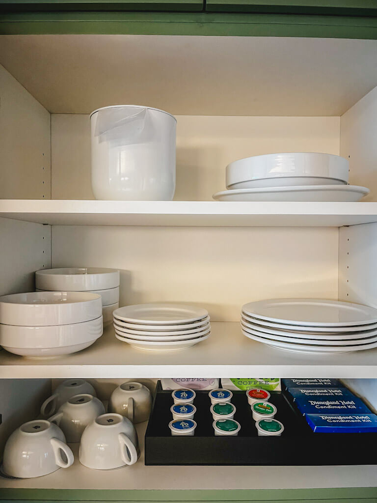 plates, mugs, k-cups, and condiment kits in the kitchen of a one bedroom villa at Disneyland Hotel.