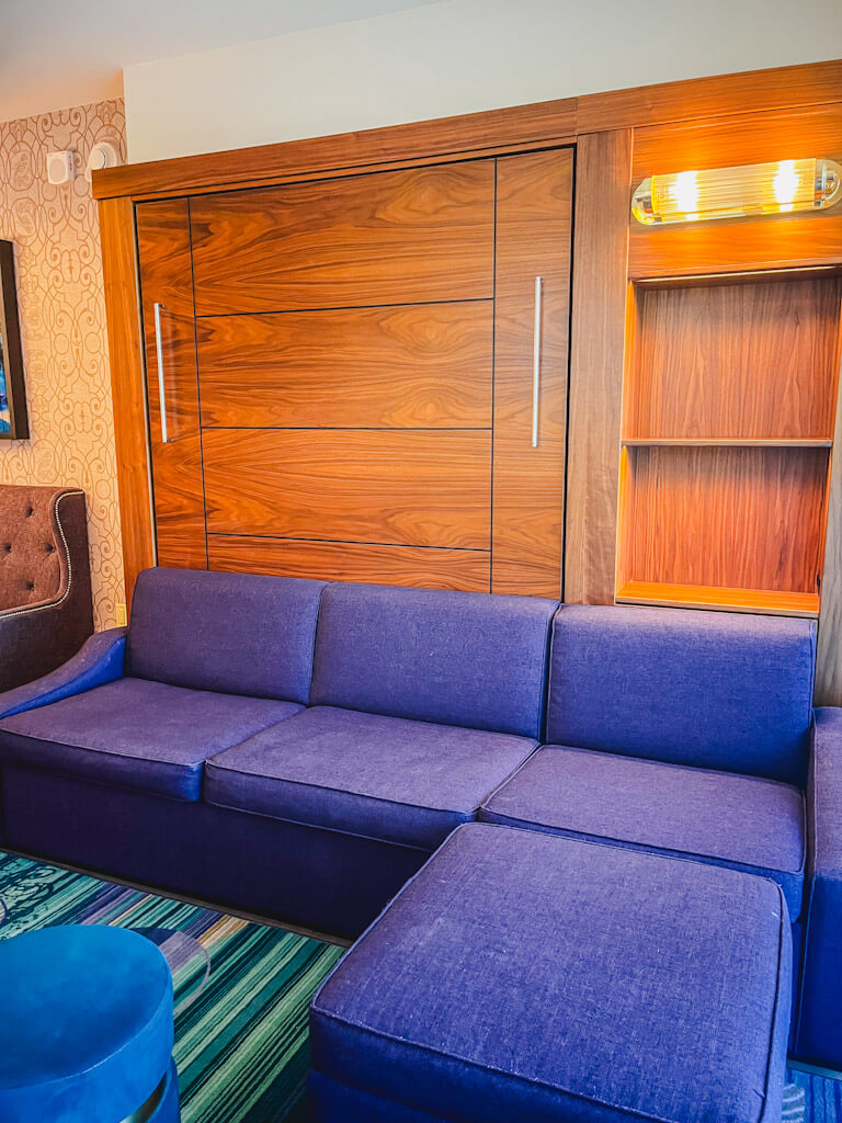 Living area with hidden bed behind the wall in a one bedroom villa at Disneyland Hotel.