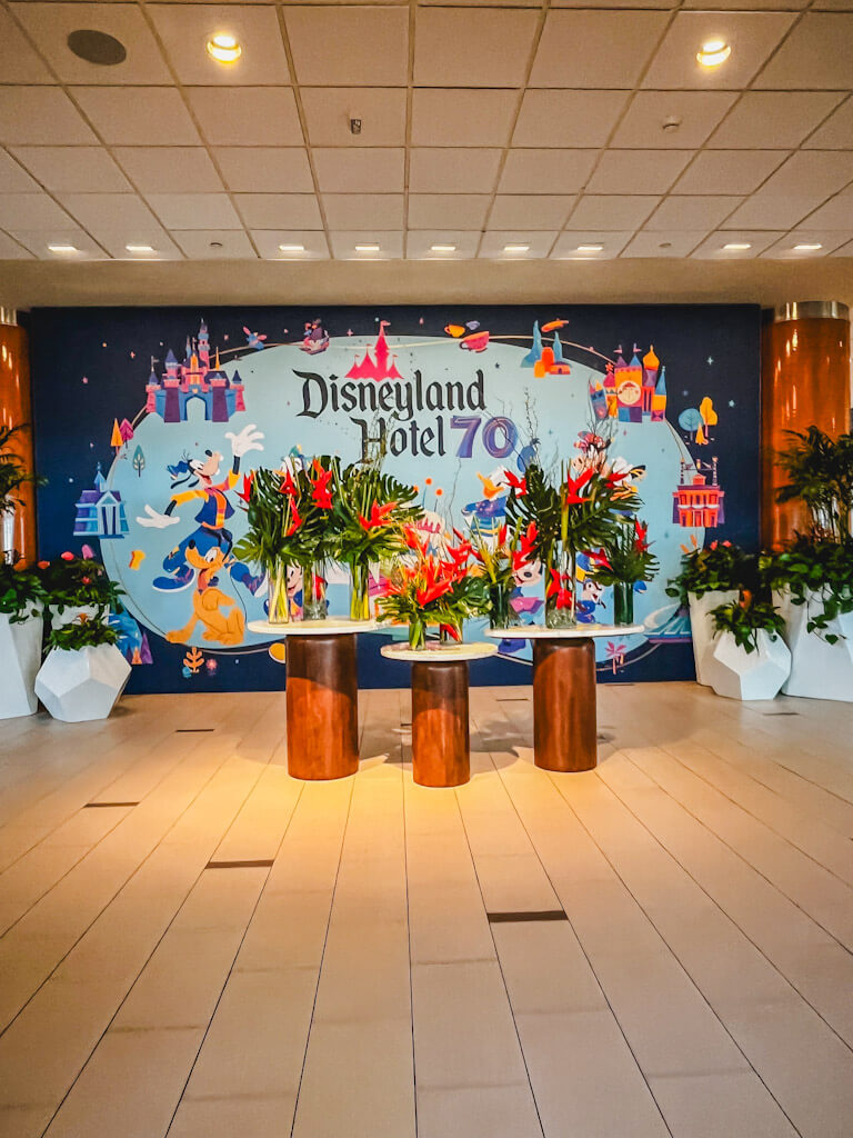 lots of flowers and a mural celebrating the 70th anniversary of the Disneyland Resort.