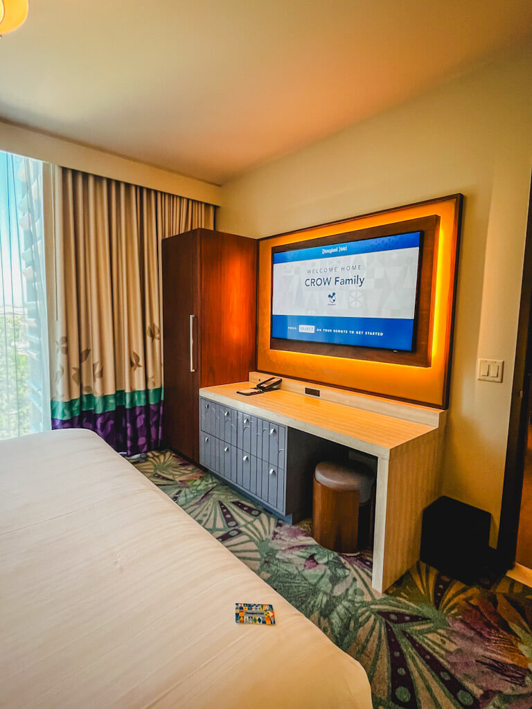 large flat screen tv mounted across from the bed in a one bedroom villa.