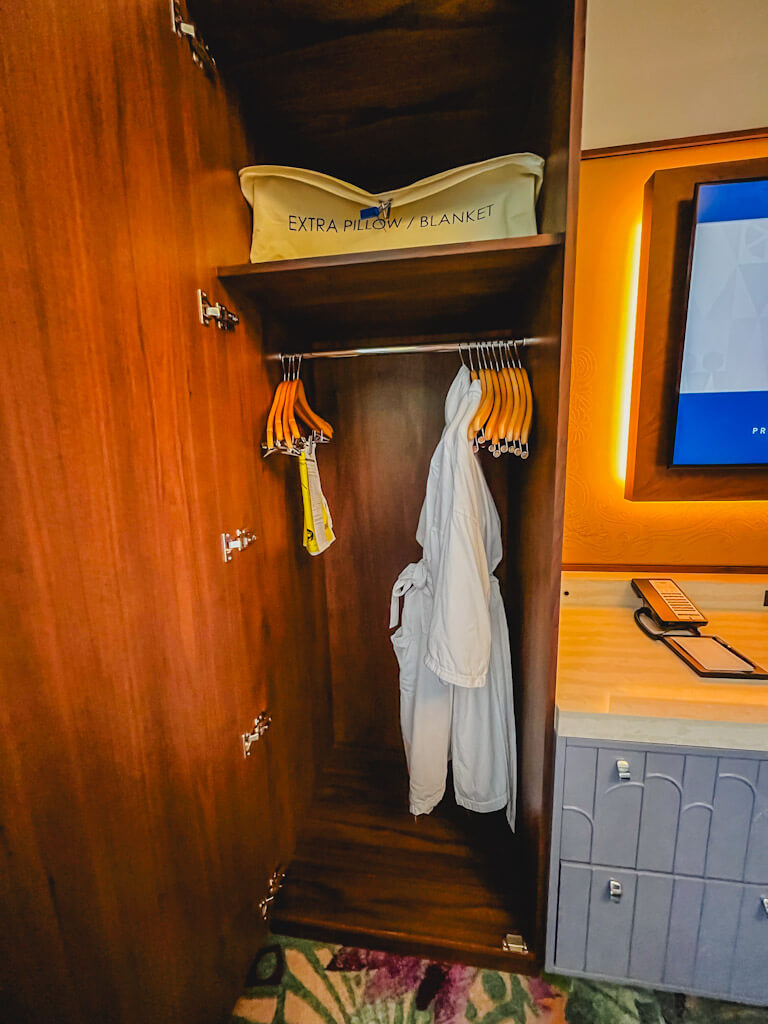 robes hanging in the closet in the master bedroom of a one bedroom villa at Disneyland Hotel.
