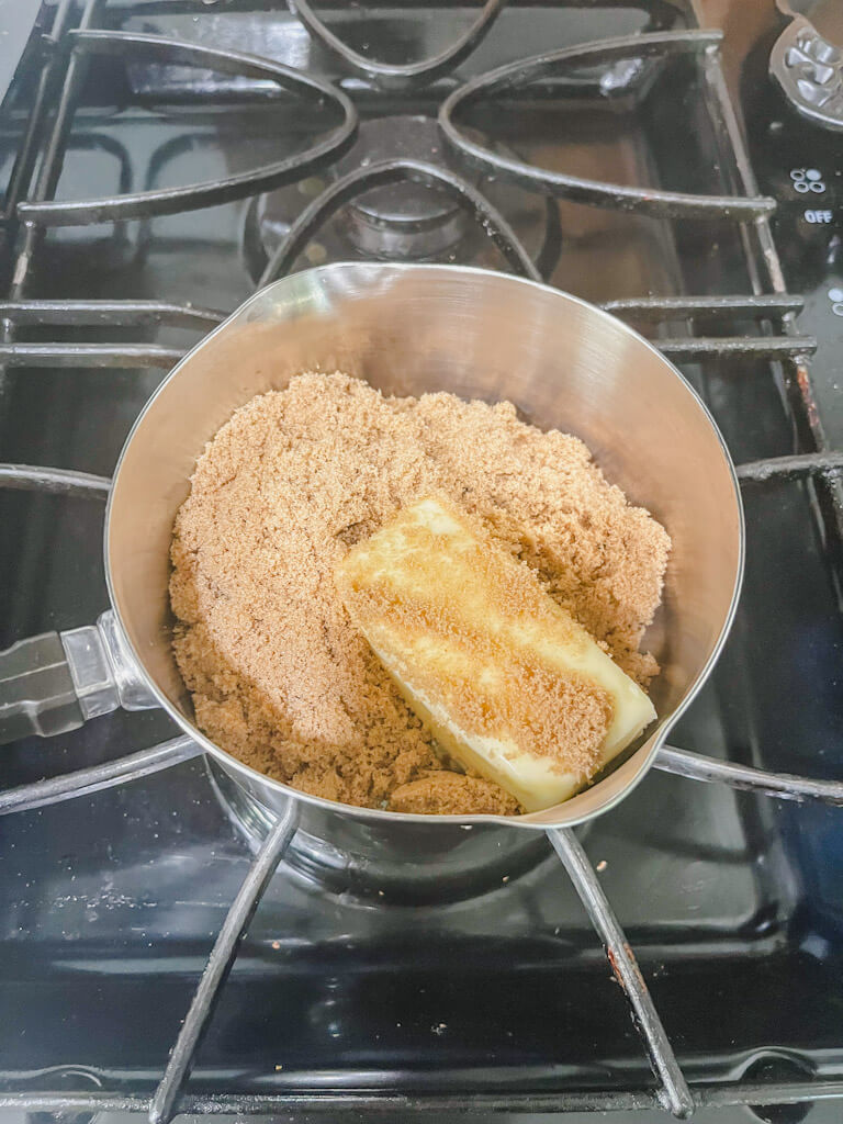 butter and brown sugar melting together in a saucepan on the stove.