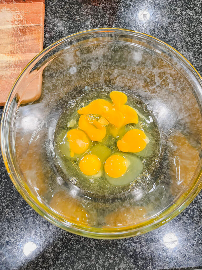 eggs in a glass bowl ready to be whisked.