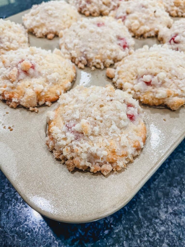 strawberry streusel muffins in the pan after baking in the oven.