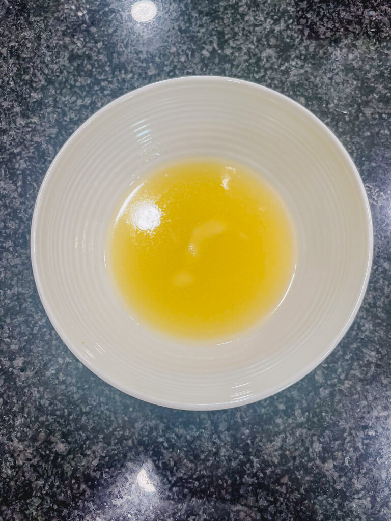 melted butter in a white bowl for the streusel crumble.